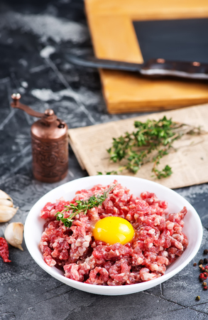 minced meat with salt and spice on a tableの写真素材