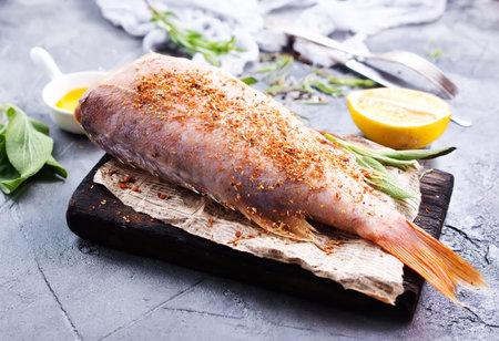 raw fish with spice and salt on a table
