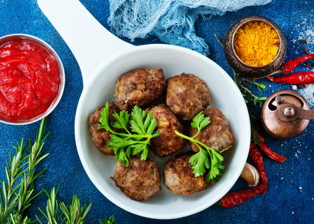 fried meatballs in bowl with spice and sauceの写真素材