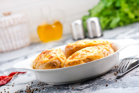 baked potato with bacon on the white plateの写真素材