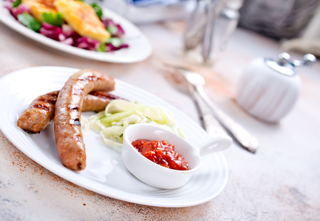 fried sausages with sauce on the plateの写真素材
