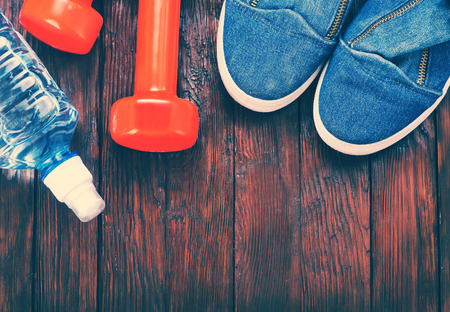 sport shoes and water on the wooden tableの写真素材