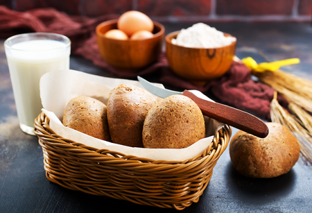 fresh wheat bread in basket and on a tableの写真素材