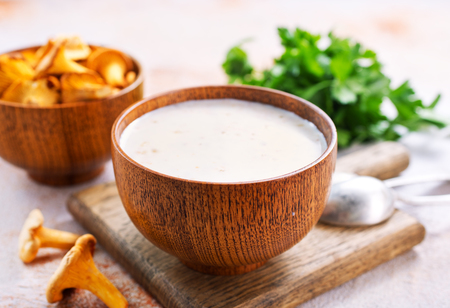 mushroom soup in bowl and on a tableの写真素材