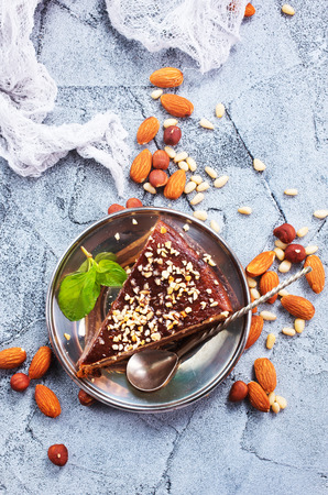 chocolate cake with nuts on a tableの写真素材