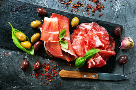 Smoked Parma ham on the black boardの写真素材