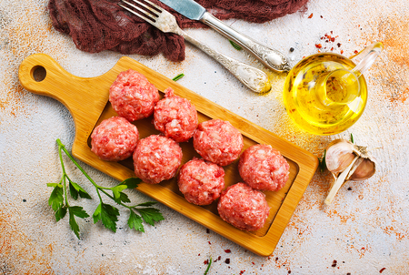 raw meatballs with aroma spice and on a tableの写真素材