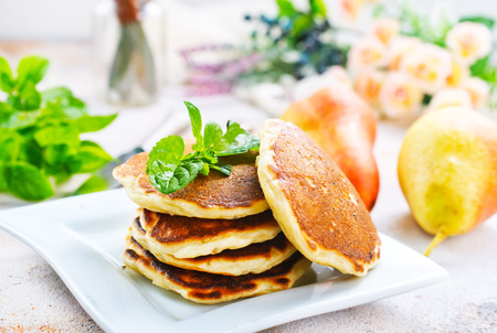 pancakes on plate and on a tableの写真素材