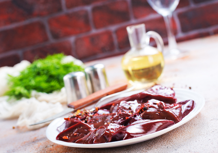 raw liver on white plateの写真素材