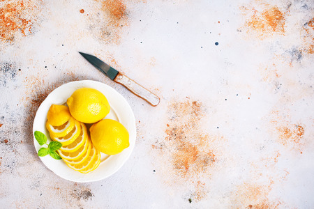 Fresh lemons and lemon slice on metal plateの写真素材