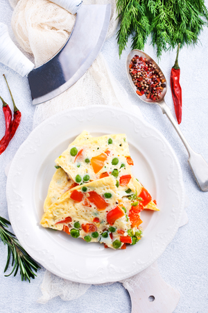 omelette with vegetables, breakfast on a tableの写真素材