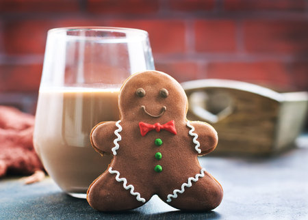 cookies and milk on a table, chocolate milk with ginger cookies