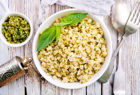 boiled bulgur with sauce Pesto in white bowlの写真素材