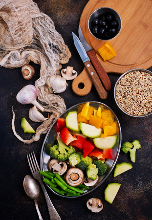 raw vegetables and mushrooms on a tableの写真素材