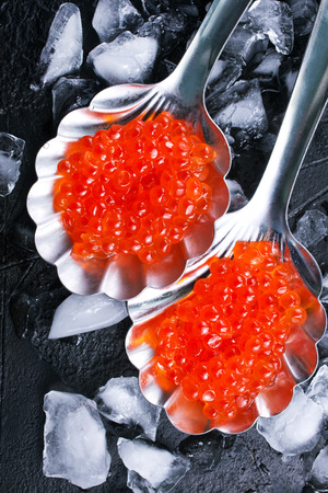 red salmon caviar, salmon caviar in metal spoonsの写真素材
