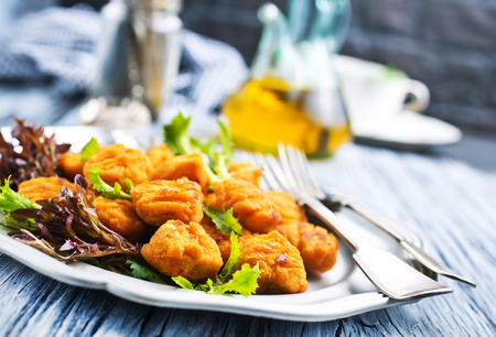 chicken nuggets with salad on plate, fried chickenの写真素材