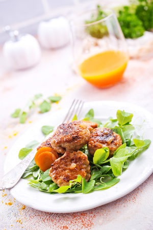 cutlets with sauce and fresh salad, cutlets on white plateの写真素材