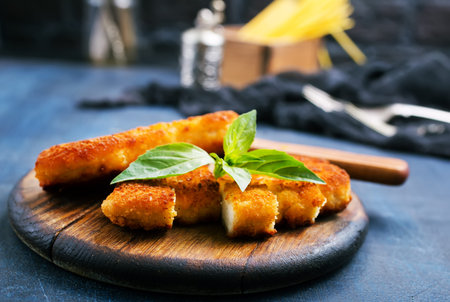 fried chicken breast on wooden board on a table