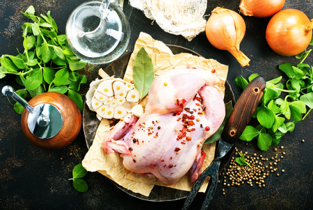 raw chicken and spice on a tableの写真素材