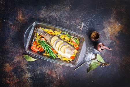 baked fish, baked fish with vegetables on plateの写真素材