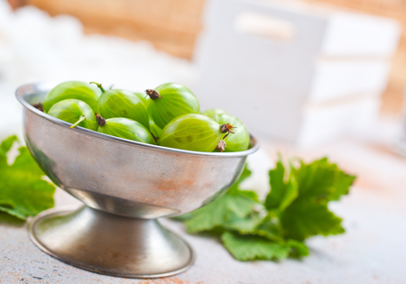 gooseberry in metal bowl, fresh gooseberry on a tableの写真素材