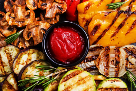 Grilled vegetables with sauce, grilled vegetables on black boardの写真素材
