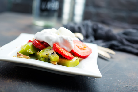 Fresh strawberry with banana kiwi and white cream. Organic food.の写真素材