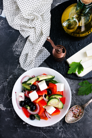 greek salad in white bowl, vegetables and fetaの写真素材