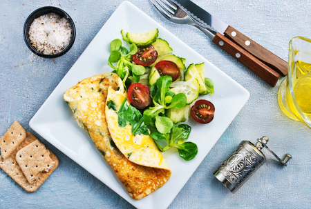 omelette with vegetable salad on the plateの写真素材