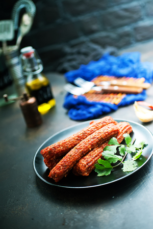 sausages on black plate, smoked sausages, sausages with spiceの写真素材