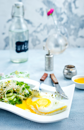 breakfast on a table, fried egg with saladの写真素材