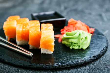 Sushi with chopsticks. Sushi roll japanese food on a tableの写真素材