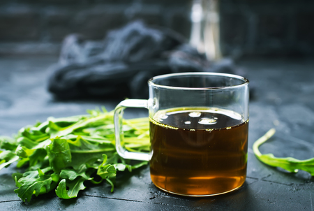 Fresh green arugula and oil. Arugula oil in glassの写真素材