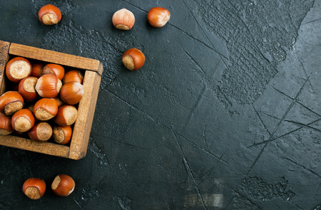 huzelnuts in wooden box on a tableの写真素材