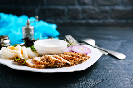 backed chicken fillet with white sauce on plateの写真素材
