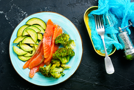 avocado broccoli and fresh salmon on the plateの写真素材