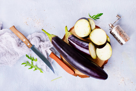 raw eggplant and knife on board, fresh eggplantの写真素材