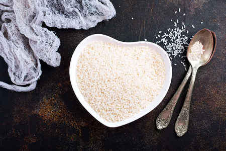 raw rice in bowl plate, rice in heart-shaped bowlの写真素材