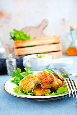fish nuggets with latuk salad on plate, fried nuggetsの写真素材
