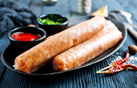 raw sausages with spice on metal plateの写真素材