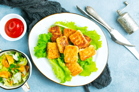 fish nuggets with latuk salad on plate, fried nuggetsの写真素材