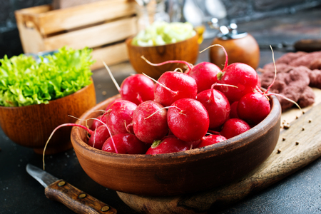 fresh radish in bowl on a tableの写真素材