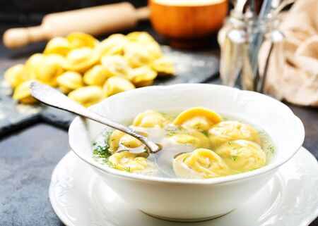 Boiled dumplings in bowl and on a tableの写真素材