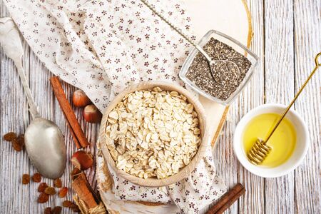 oat flakes with nuts and raisin, oat flakes in wooden bowlの写真素材