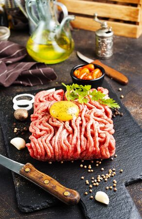 Raw minced meat with egg, herbs and spicesの写真素材