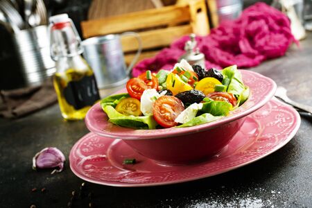 salad with tomato cheese and black olivesの写真素材