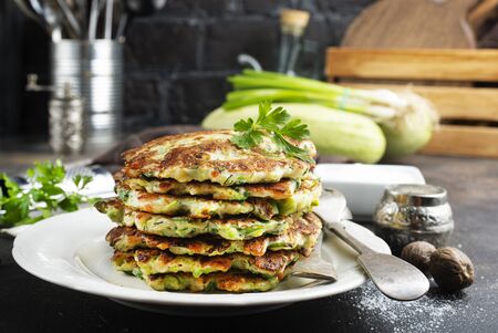 Vegetarian zucchini pancakes stack with sour cream. Vegetable pancakesの写真素材
