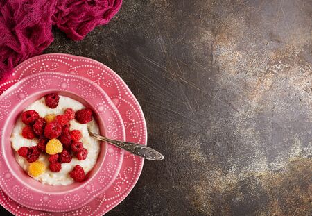 oat flakes with fresh raspberry in bowlの写真素材