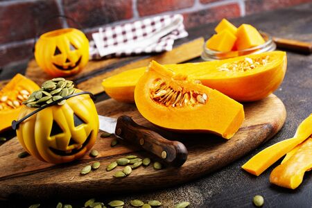 raw pumpkin and pumpkin seed on boardの写真素材