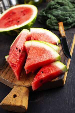 watermelon on wooden board on a tableの写真素材